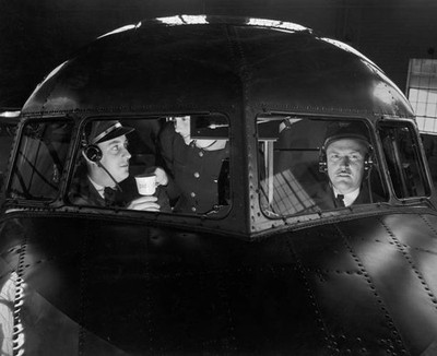 Female flight attendant serves coffee to pilot co pilot cockpit of - Old Photo