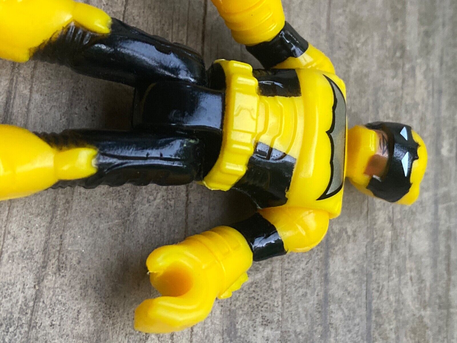 Black and yellow Batman action figure near MacBook Pro photo