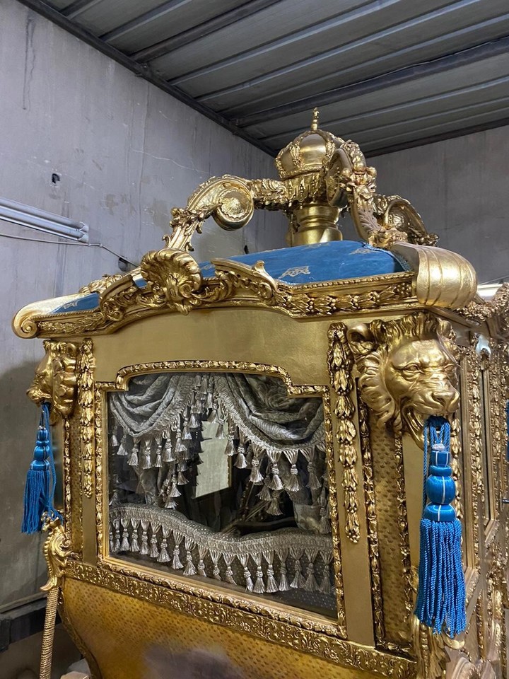 Exquisite Red And Gold Horse-Drawn Carriage Displayed Elegantly On A Pristine 10722727