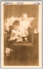 Vtg B&W Snapshot Two Toddler Babies Sitting On Porch Chair June 1934