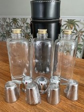3 Unused Trio of Glass Hip Flasks in a leather  Cylindrical Case.