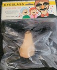 American Novelty Comedy Eyeglass Big Nose Set in sealed plastic packaging with yellow box and black nose piece.