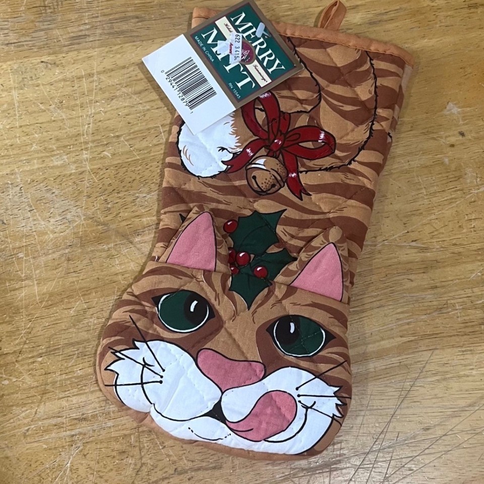 A deadstock kitsch holiday oven mitt featuring an orange tabby cat — the kind of gloriously specific vintage Christmas novelty that immediately wins a white elephant exchange.