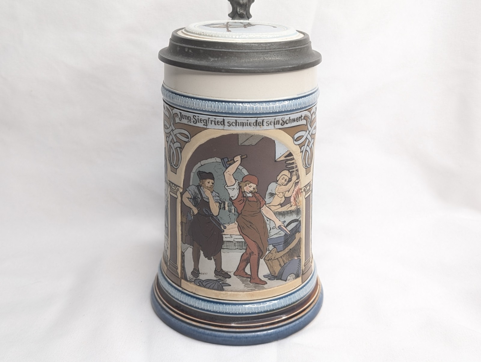 Mettlach Stein No. 2394. “Three Scenes from Siegfried's Youth" .5L, inlaid lid