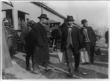 Photo:Men,US Internal Revenue Bureau carrying confiscated liquor,African