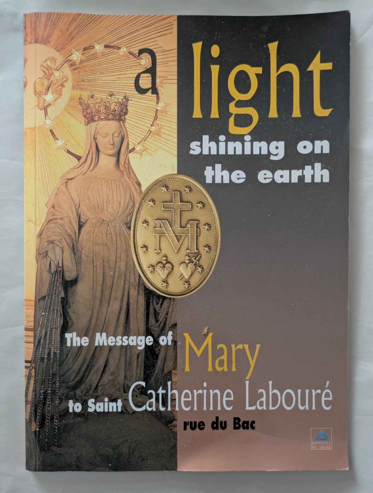 A light shining on the earth message of Mary  Catherine Laboure Miraculous Medal