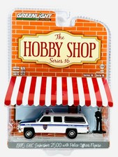 1985 GMC Suburban 2500 w/ Police Officer Hobby Shop Series 16 1:64 by Greenlight