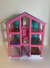 3 Story Dollhouse Without The Play Set Pieces. The Color Is Pink, And Green.