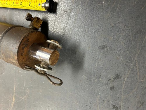 Close-up of worn brass deck lift hydraulic cylinder with visible metal ...