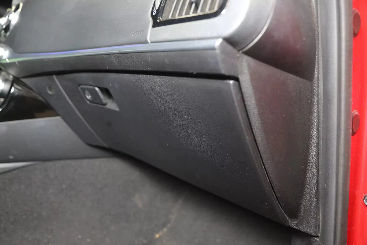 A vehicle's glove box, behind which sits the vehicle's cabin air filter.