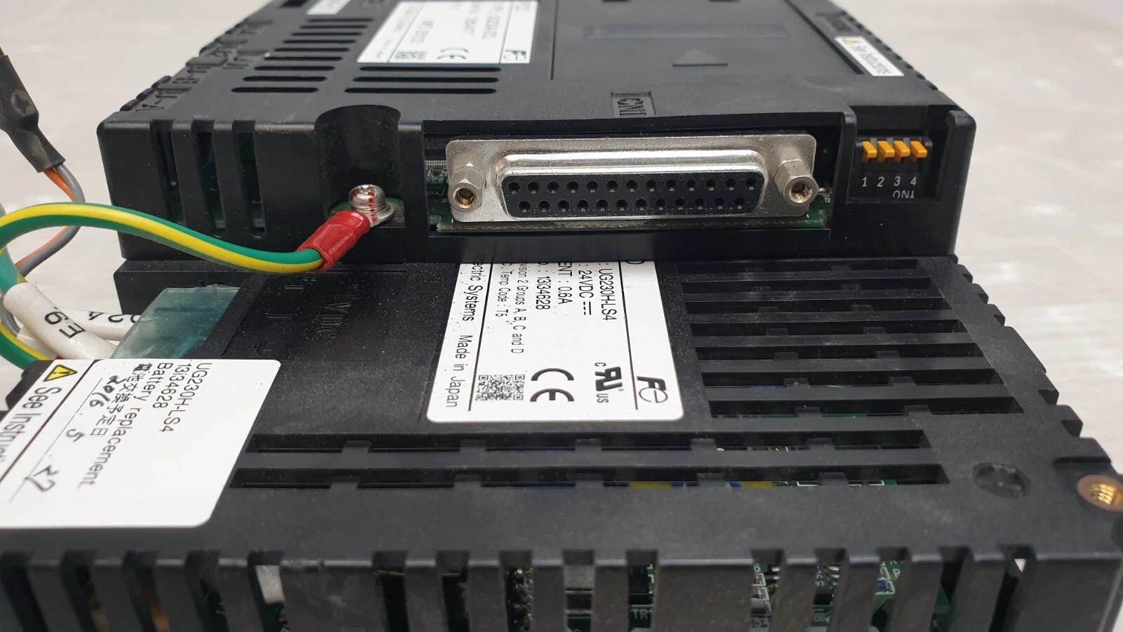 25-pin D-sub PLC port and DIP switches on the Fuji UG230A-DCL