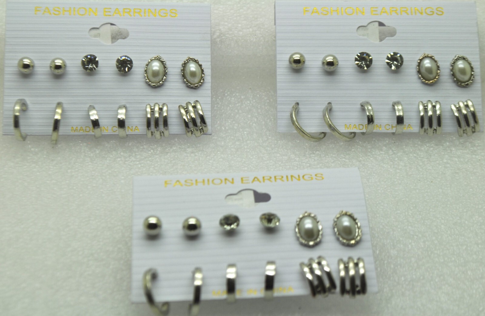 Wholesale lot of 18 Paris-inspired silver stud fashion earrings in multi styles