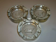 Lot of 3 Vintage Ashtrays clear glass heavy with embossed logo of dove or ? 