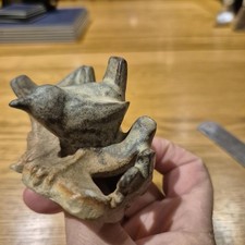 Vintage stoneware figurine of a bird on a branch. Studio pottery folk art style.