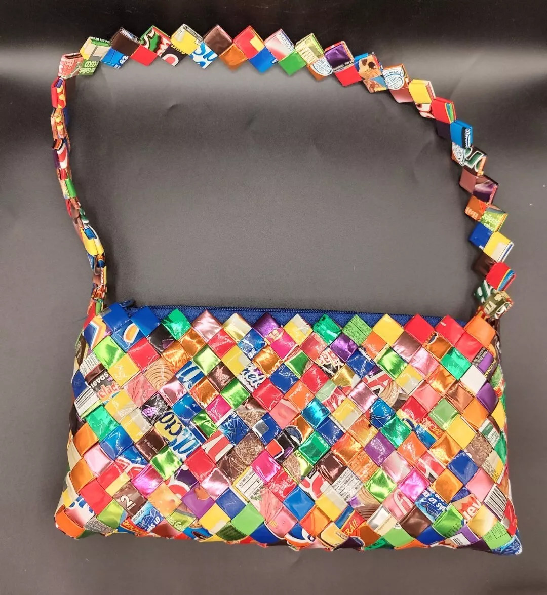 These handbags are made from recycled candy wrappers, food packages,  magazines, and other recycled materials.… | Eco friendly handbags, Purses  and bags, Bag display