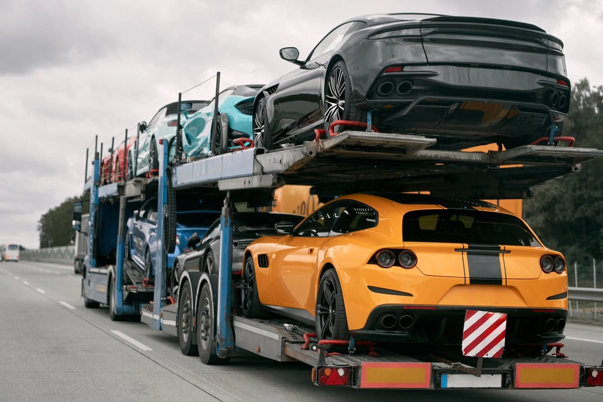 Sports cars on two-level car hauler.