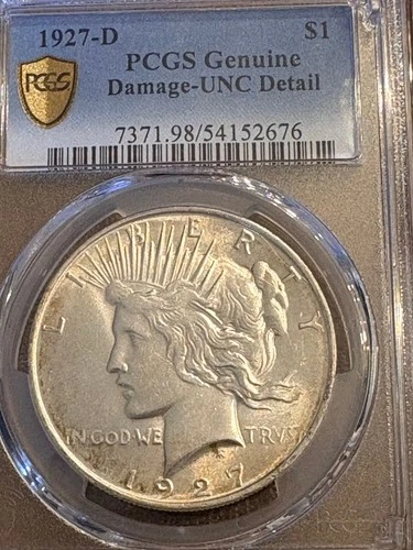 1927d PCGS UNC detail damage peace dollar