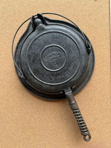Antique Wagner Ware cast iron waffle iron with a patent date of February 1910