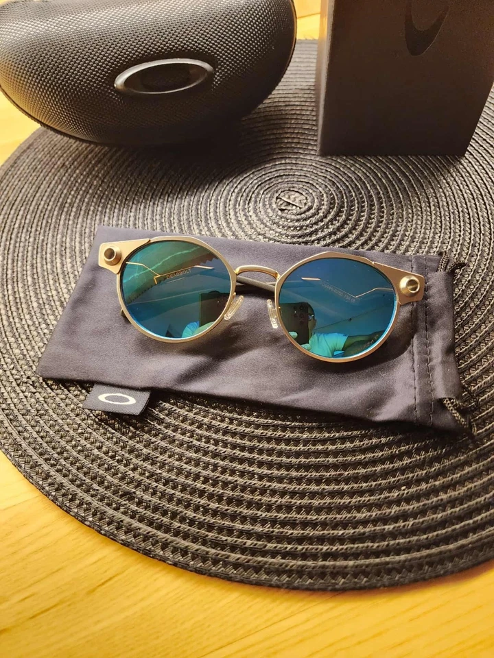 Lente polarizada Oakley Deadbolt marco de metal titanio azul Prizm totalmente nueva Foto 2 de 4