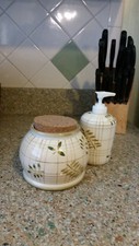 Ivory ceramic hand soap dispenser w/matching ceramic canister.