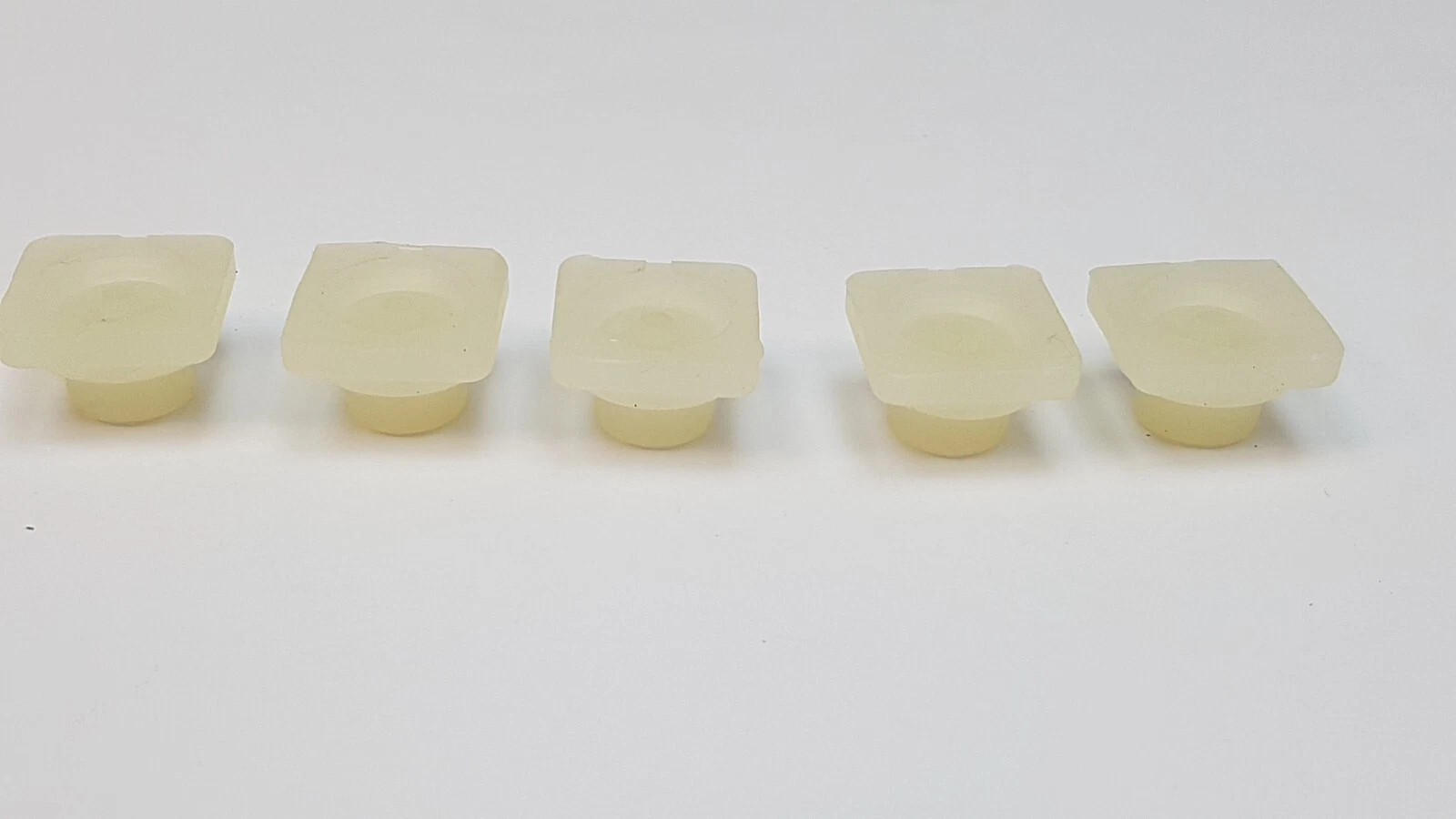 Side view of five Lumenis enable knobs showing the stem under each flange