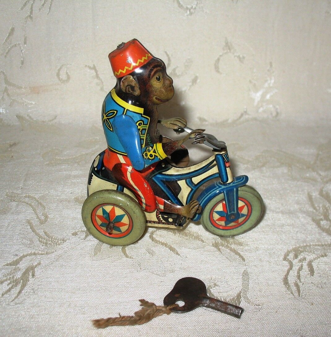 Monkey riding Tricycle marked US Zone Germany Wind-up Tin Monkey riding Tricycle marked US Zone Germany Wind-up Tin