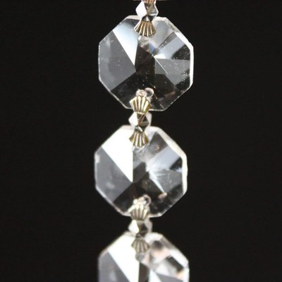 Clear 14mm leaded octagon chain with hanger on both ends; used for draping acros
