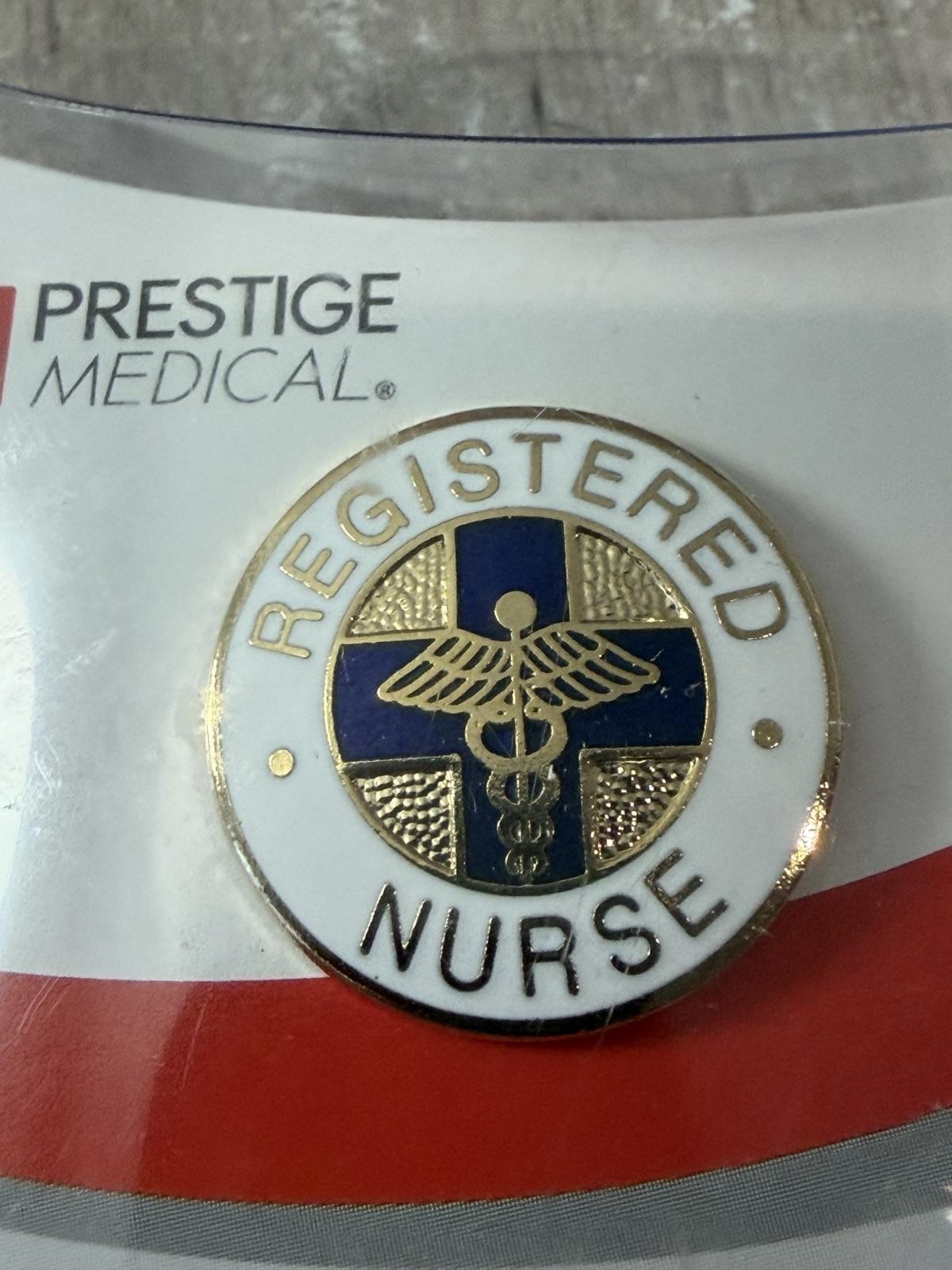 как выглядит Prestige Medical RN Registered Nurse Pin Emblem Blue Cross Caduceus 7/8" фото