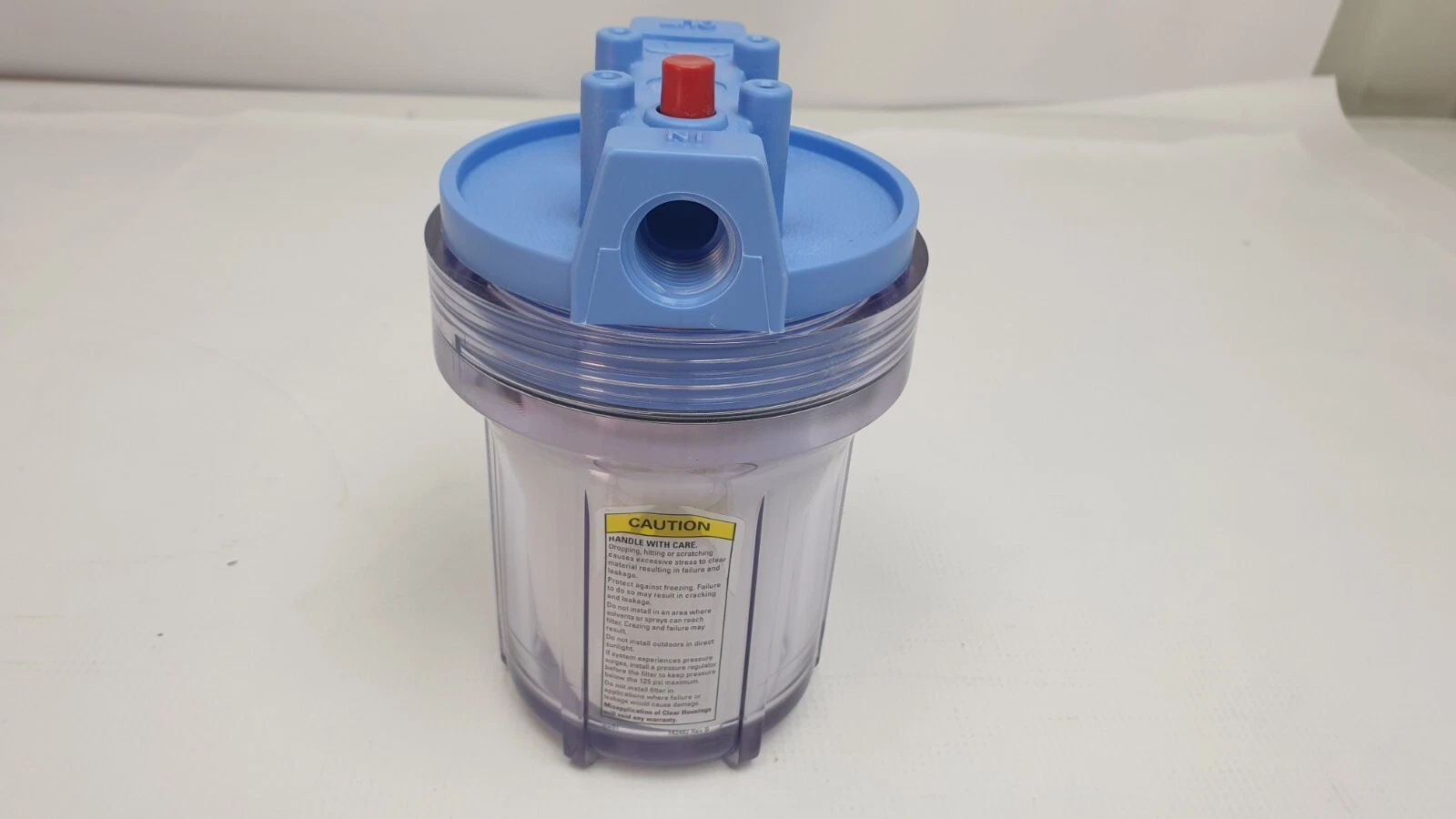 Pentek 158216 filter housing, inlet side, with caution label on the clear sump