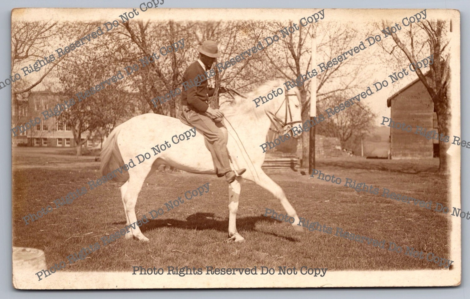Antique RPPC man riding horse in park Real Photo Postcard 