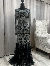 Black Silver Long Sleeve Formal Gown with Feathered Hem and Embellishments