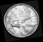 1959 25¢ silver coin in a paper flip