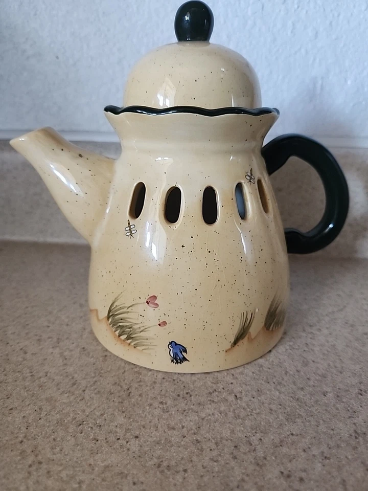 Tetera a la sombra de velas con pájaros azules y flores de interiores de casas en Texas Foto 4 de 4