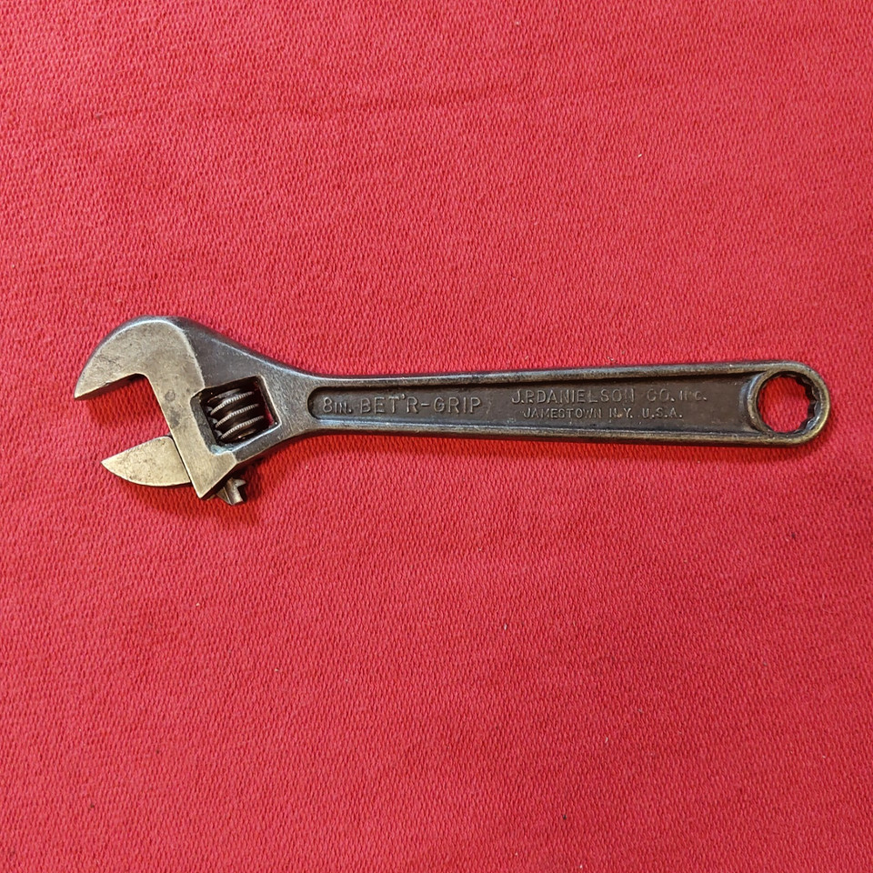 A dual-function vintage wrench with an unusual ergonomic grip design — the kind of quirky industrial artifact that looks great on a workshop shelf or desk.