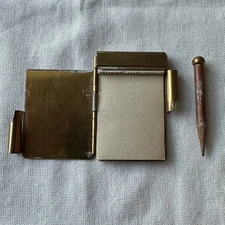 Vintage brass mini mechanical notepad with pencil and paper.