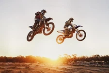 Motocross Riders Jumping Over Sunset Photo Laminated Poster 36x24