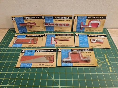 8 VINTAGE MARX POCKET TOOLS IN PACKAGES ON CARD. (P2)