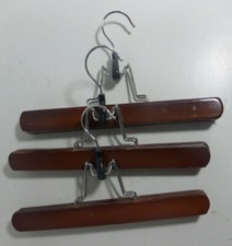 3x clamp type clothes hangars dark colored wood