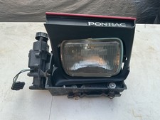 1982-84 Firebird Trans Am Drivers Side Headlight Assembly With Mounting Brackets 1982-84 Firebird Trans Am Drivers Side Headlight Assembly With Mounting Brackets
