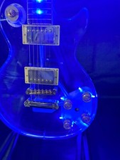 The new LP acrylic electric guitar is surrounded by blue LED lights on the body