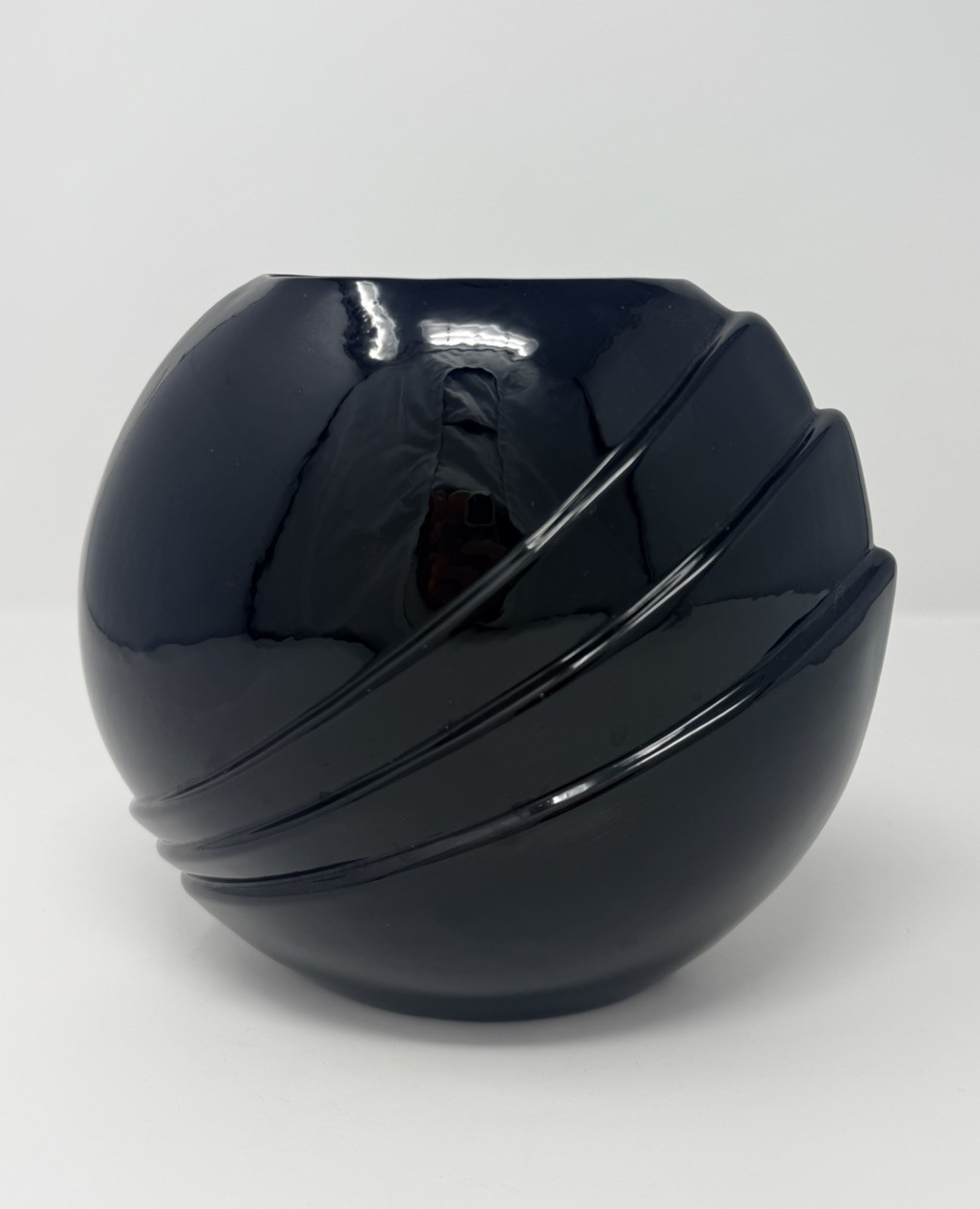 Black glazed sculptural ceramic orb vase with diagonal cutaway