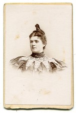 ROUND FACED WOMAN WITH HAIR TWISTED TO POINT UP WORDS. CDV.