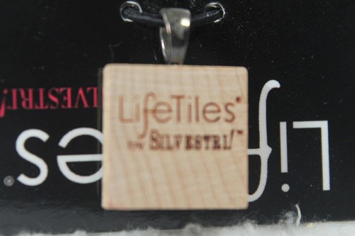 Square wooden pendant with silver metal loop, featuring white “LifeTiles” text and black “Lovestrikes” branding.