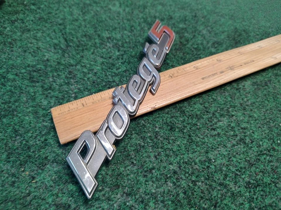 99 00 01 02 03 MAZDA PROTEGE 5 EMBLEMA CROMADO TRASERO LOGOTIPO INSIGNIA SÍMBOLO USADO OEM 4S4 Foto 3 de 4