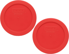 Two red Pyrex 7200-PC 2-cup food storage replacement lids with black logo and white circular text on top.