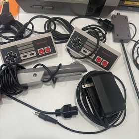 Nintendo NES Console Bundle + 11 Games Mario NFL Controllers Gun Cords Booklets