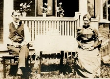 Grandfather and grandmother with three flowering plants 1910s era RPPC RP1