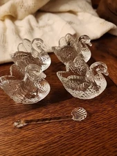 4 Swan Glass Dishes. Maybe Salt Peters. 1 Spoon.