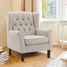 Fauteuil à oreilles capitonné, accoudoirs roulés, bois massif, coussin amovible