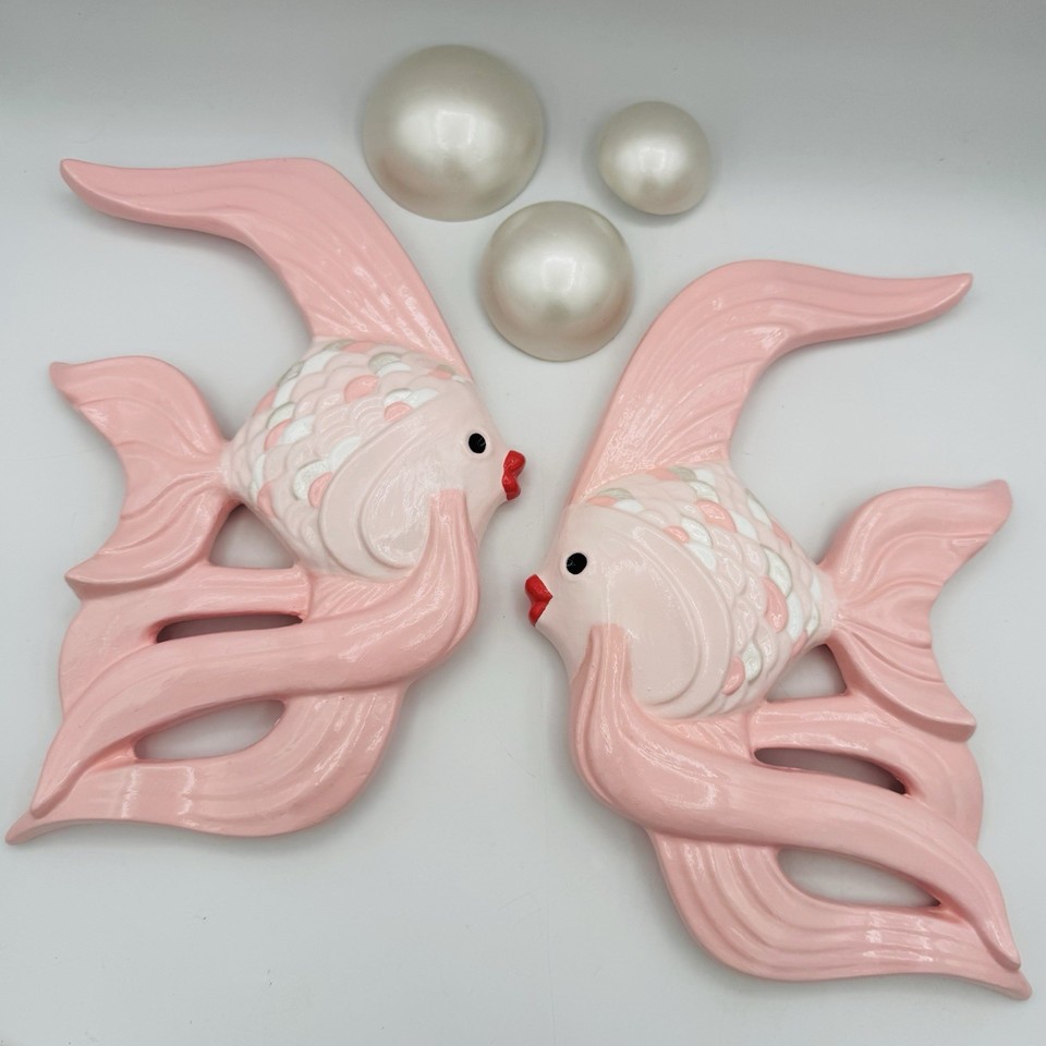 A kitschy pink chalkware fish wall plaque that nails that retro diner / grandma's-beach-house aesthetic people are actively hunting for.